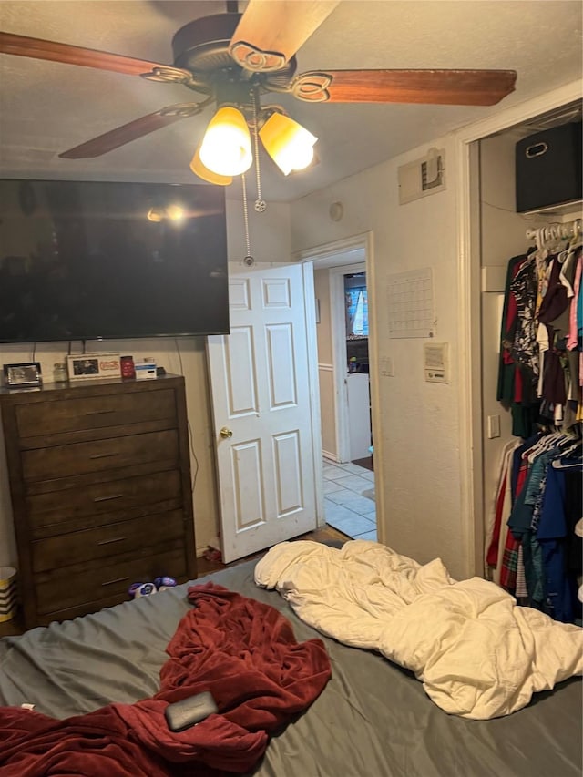 bedroom featuring a closet, visible vents, and a ceiling fan