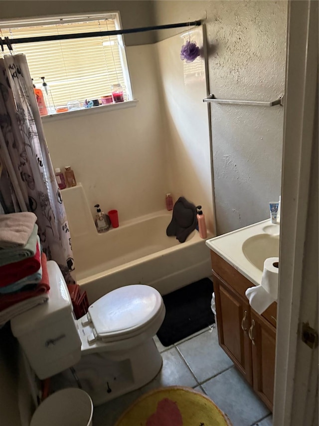 full bath featuring tile patterned floors, shower / bath combo with shower curtain, toilet, and vanity