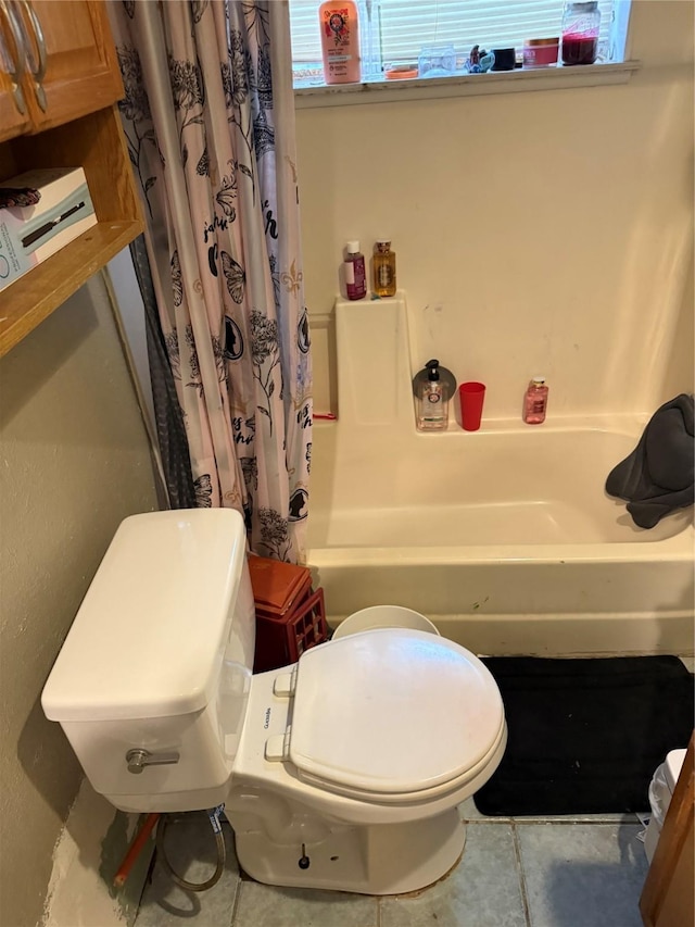 bathroom with toilet and tile patterned flooring