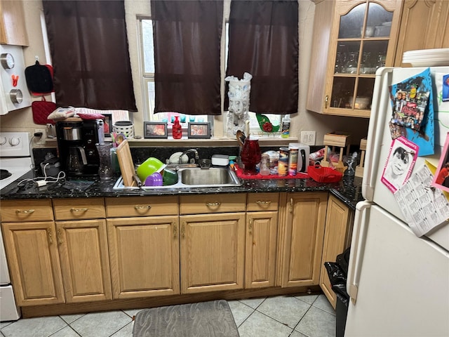 kitchen with light tile patterned floors, white appliances, glass insert cabinets, and a sink