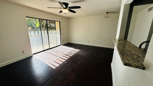 unfurnished living room with visible vents, a ceiling fan, baseboards, and wood finished floors