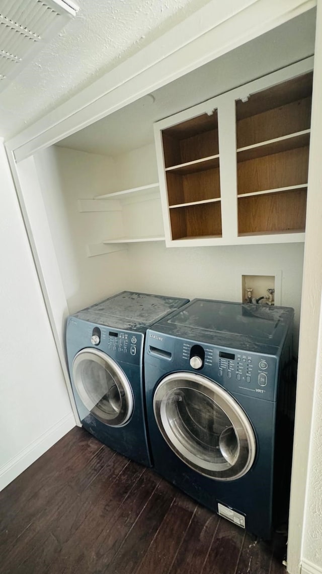 washroom with washer and clothes dryer, laundry area, dark wood-type flooring, and baseboards