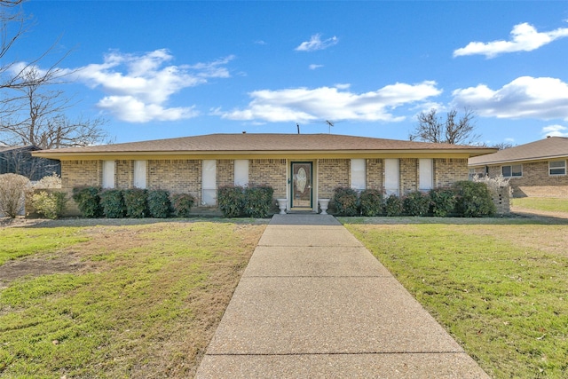 ranch-style home with brick siding and a front yard