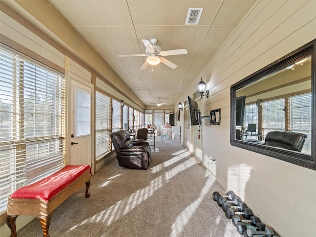 sunroom featuring visible vents and ceiling fan