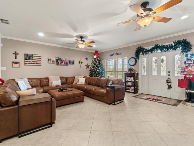 living room with light tile patterned floors, visible vents, crown molding, and a ceiling fan