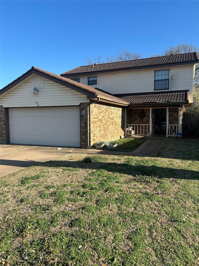 traditional home featuring brick siding, driveway, an attached garage, and a front lawn