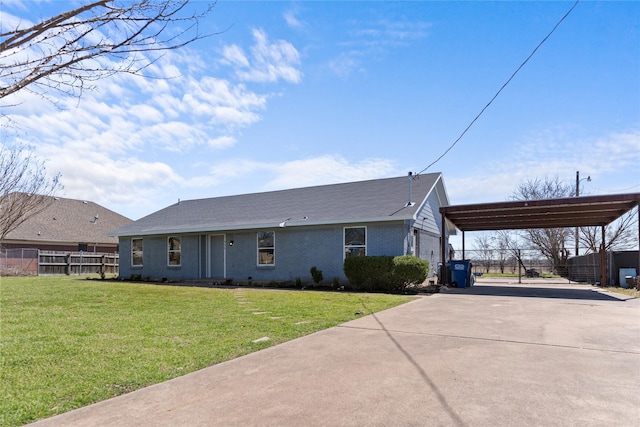 view of front of property with a front lawn, fence, concrete driveway, a carport, and brick siding