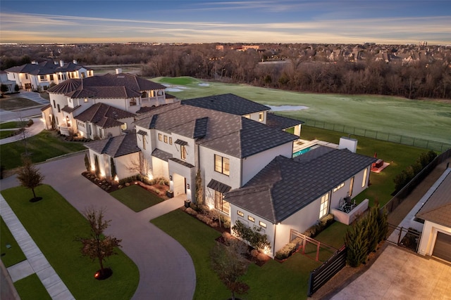 aerial view at dusk featuring a residential view