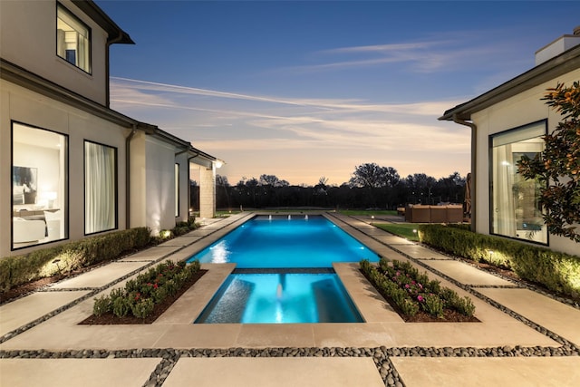 804 Kimball Ct, Allen, TX 75013 - pool at dusk with a pool with connected hot tub and a patio area