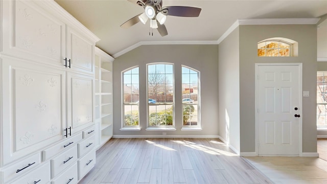 entrance foyer with crown molding, baseboards, lofted ceiling, light wood-style flooring, and a ceiling fan