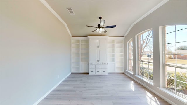 unfurnished sunroom with visible vents, a ceiling fan, and vaulted ceiling