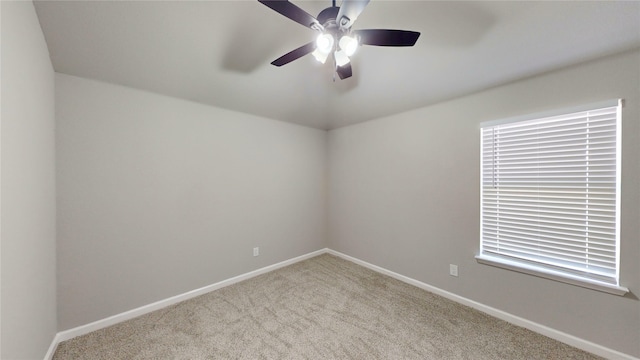 unfurnished room featuring baseboards, carpet, and a ceiling fan