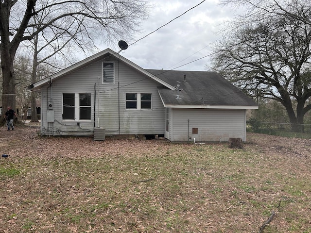 rear view of house featuring central AC and fence