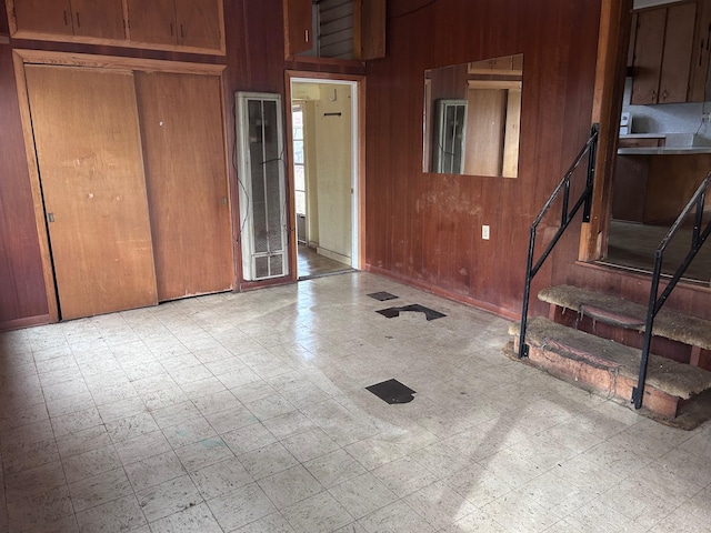 interior space featuring tile patterned floors and wooden walls