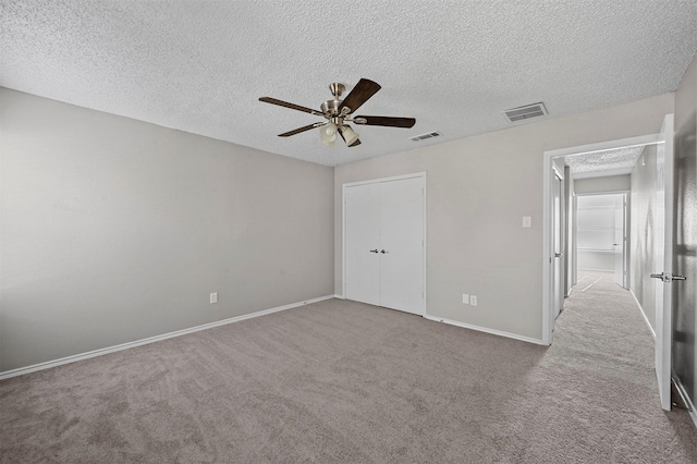 unfurnished bedroom featuring visible vents, baseboards, a ceiling fan, and carpet flooring