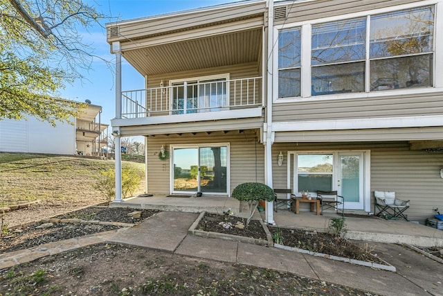 back of house with a patio and a balcony