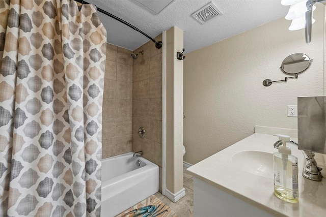 full bathroom with visible vents, shower / bath combo with shower curtain, a textured ceiling, vanity, and a textured wall