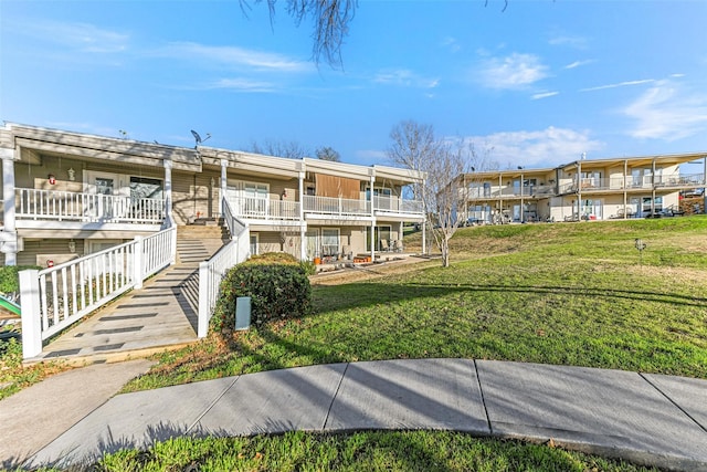 view of community featuring stairway and a lawn