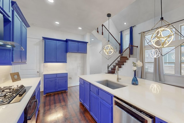 kitchen with blue cabinets, oven, a sink, gas cooktop, and stainless steel dishwasher