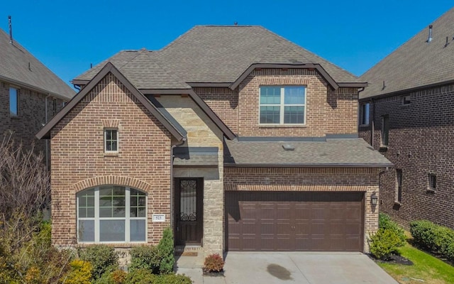 view of front of home with brick siding, stone siding, concrete driveway, and roof with shingles