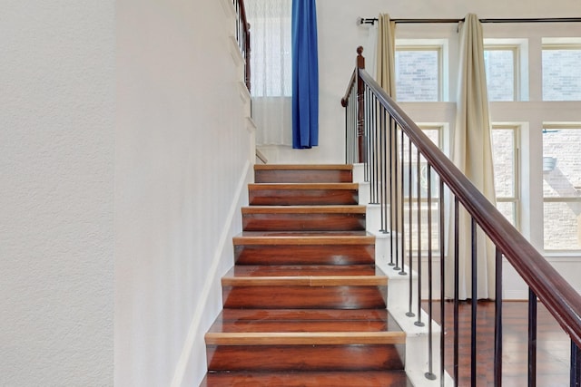 staircase featuring baseboards