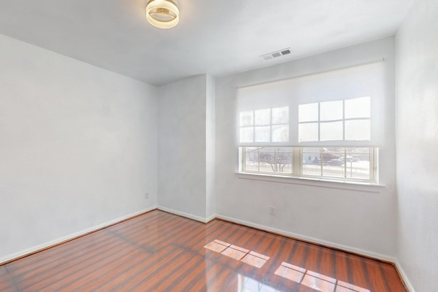 unfurnished room with visible vents and baseboards