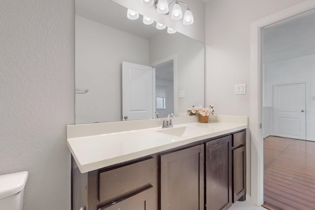 half bathroom with vanity and toilet