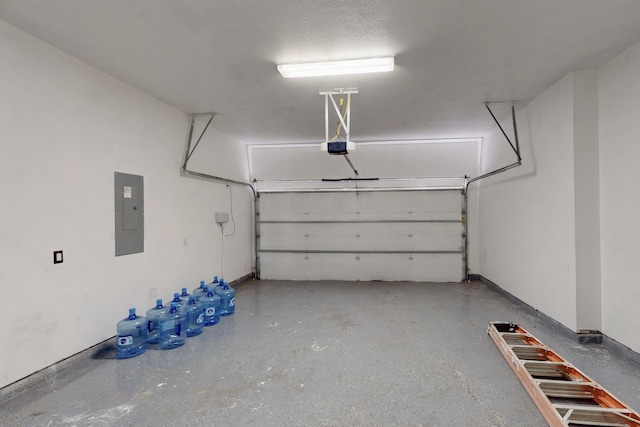 garage featuring electric panel, a garage door opener, and baseboards