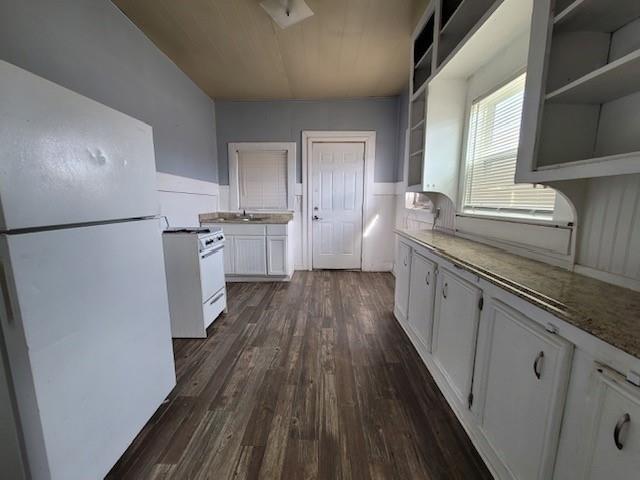 kitchen with dark wood-type flooring, open shelves, a sink, white appliances, and white cabinets