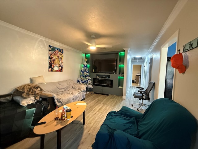 living room with attic access, wood finished floors, and ornamental molding