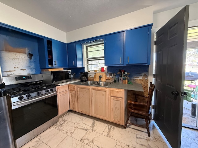 kitchen featuring a sink, stainless steel appliances, blue cabinetry, and marble finish floor