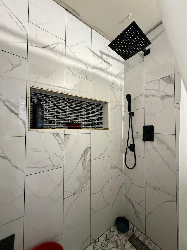 bathroom with a tile shower