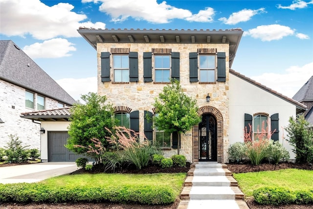 view of front of home featuring stone siding and driveway