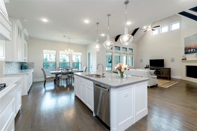 kitchen featuring a sink, dark wood-style floors, dishwasher, and open floor plan