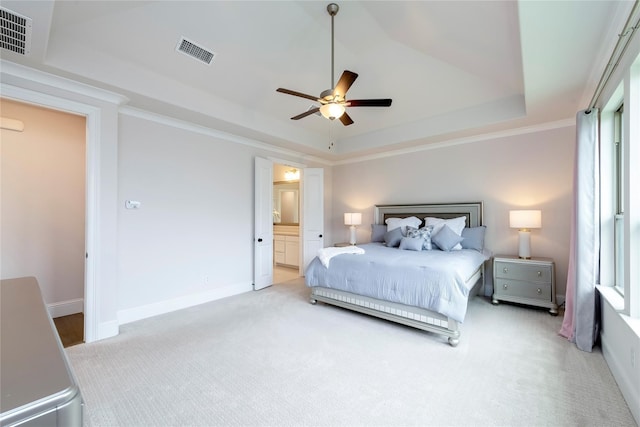 bedroom featuring visible vents, a raised ceiling, baseboards, and carpet floors