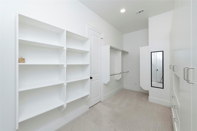 spacious closet featuring visible vents and light carpet