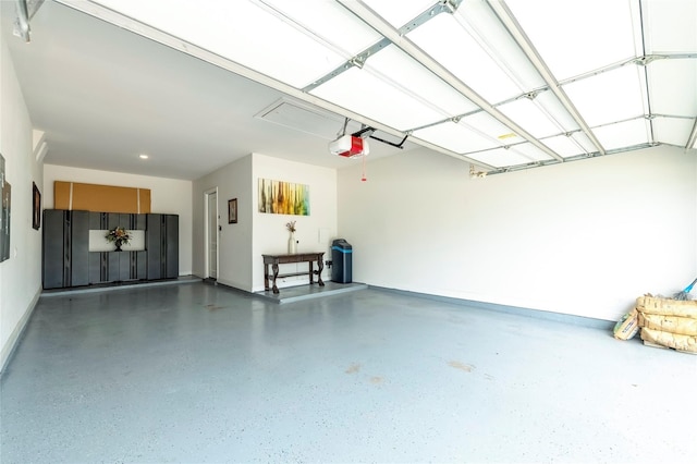 garage featuring a garage door opener and baseboards