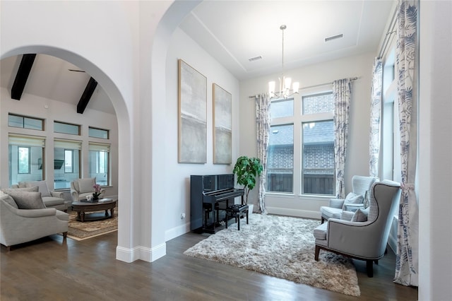 sitting room with visible vents, beamed ceiling, baseboards, and dark wood-style flooring