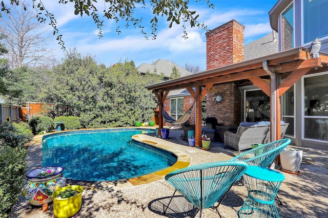 pool with a patio and fence