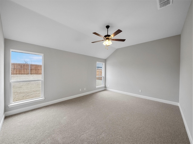 spare room with ceiling fan, carpet, visible vents, and baseboards