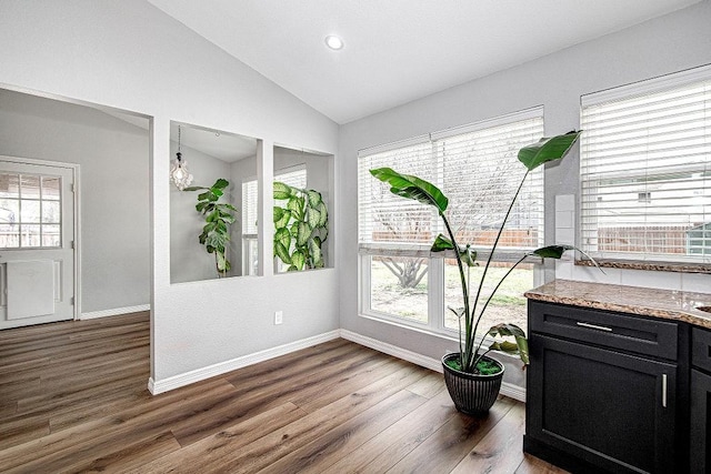 interior space with lofted ceiling, recessed lighting, baseboards, and dark wood-style flooring