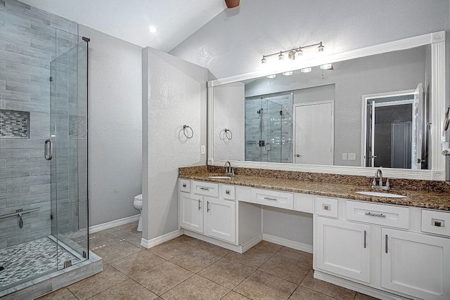 bathroom featuring a stall shower and a sink