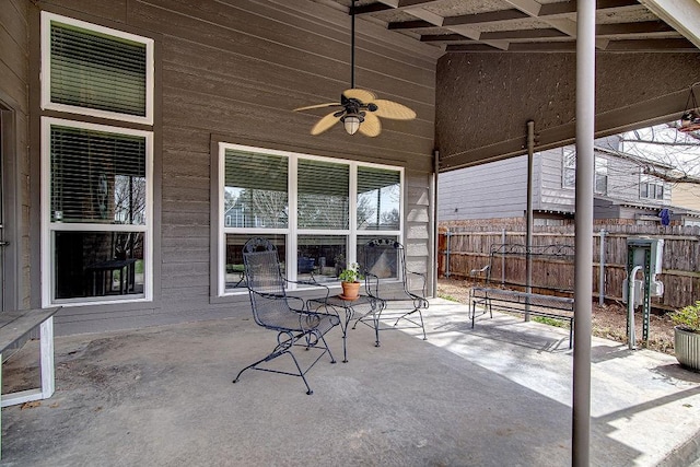 view of patio with ceiling fan and fence