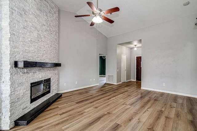 unfurnished living room with wood finished floors, visible vents, baseboards, a fireplace, and ceiling fan