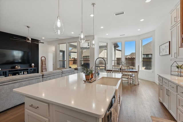 kitchen featuring dark wood finished floors, open floor plan, light countertops, and visible vents