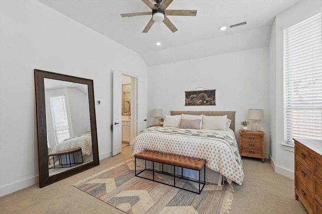 bedroom featuring vaulted ceiling, baseboards, visible vents, and light carpet