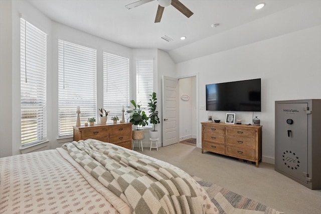 bedroom with visible vents, multiple windows, light colored carpet, and vaulted ceiling