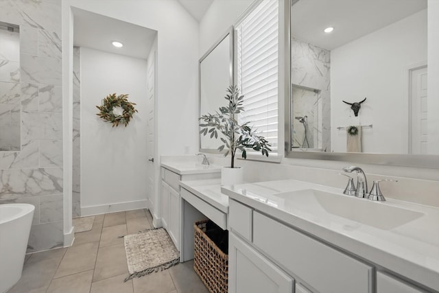 full bath featuring a freestanding tub, two vanities, a sink, recessed lighting, and walk in shower