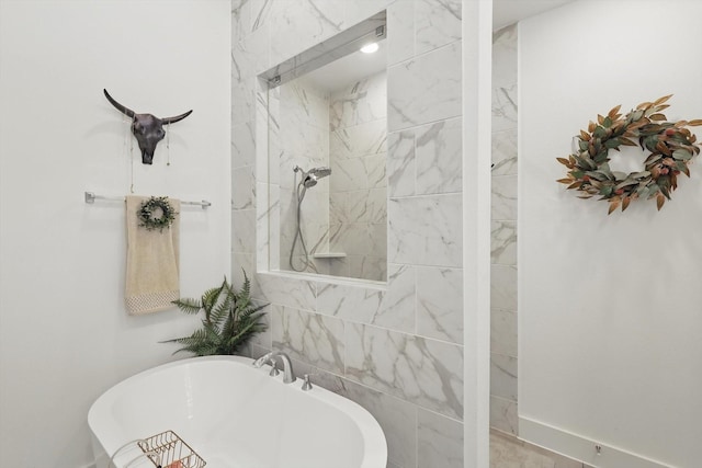 bathroom featuring tiled shower and a freestanding bath