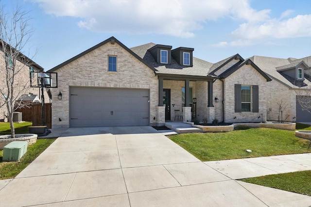 view of front facade featuring brick siding, a shingled roof, central AC, a front yard, and driveway